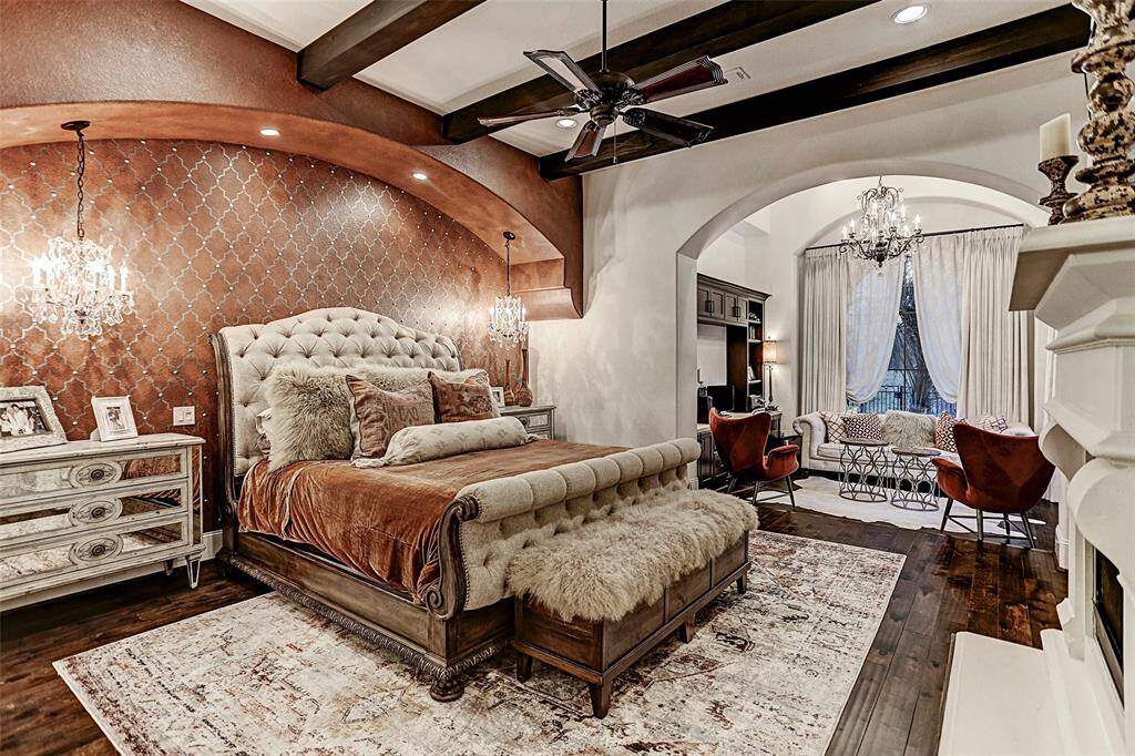 Master Suite | Notice all the details this master bedroom has in it! The wood-beamed ceiling, designer paint, hanging chandelier lights and hardwood floors complete this room