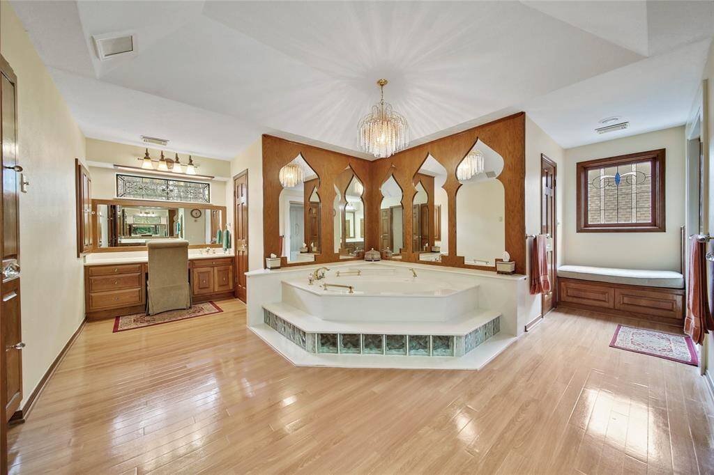 Spacious upstairs owner's bath has separate vanity areas, jacuzzi tub and walk in shower. Plus a nice sitting area outside the shower!