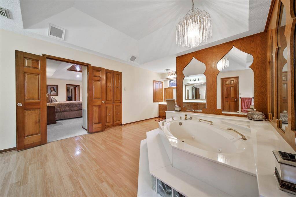 Built in storage areas. Double doors lead to the bedroom. Look at that gorgeous chandelier!