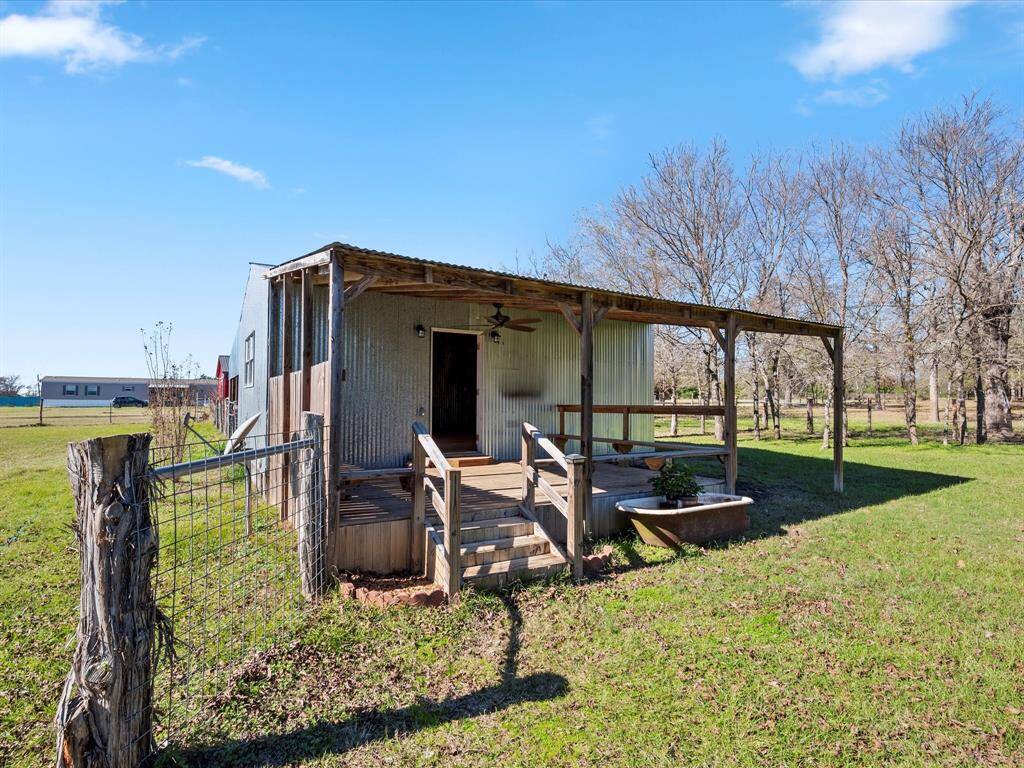 Porch view of building next to home. Perfect to be converted or she shed/man cave.
