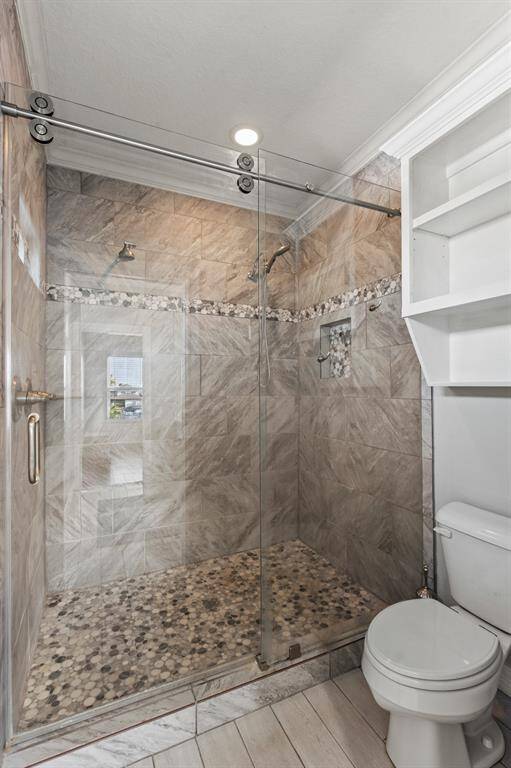 This shower is huge, beautiful neutral tile and double shower heads!