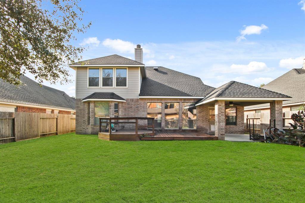 large backyard with extended deck and covered patio