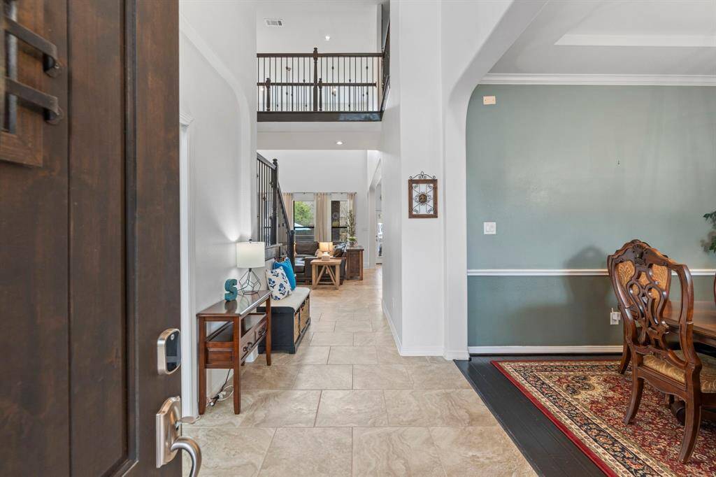 Soaring ceilings greet you in this grand foyer.
