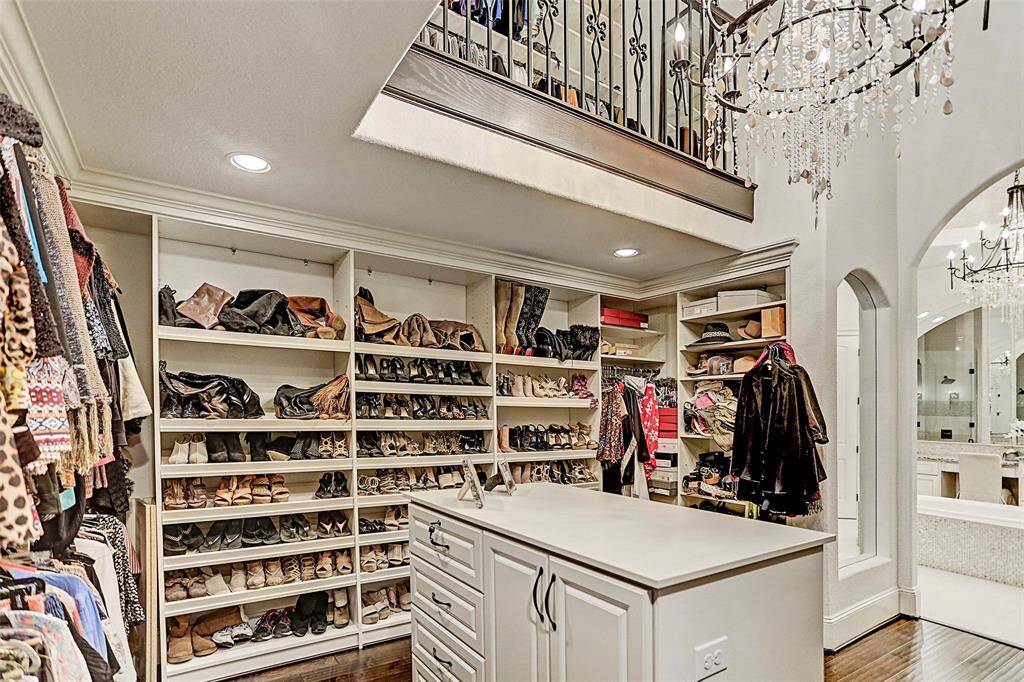 "Hers" Two-Story Master Closet | Clothes racks, shoe racks, a dressing counter with built-in drawers, What more could you want!