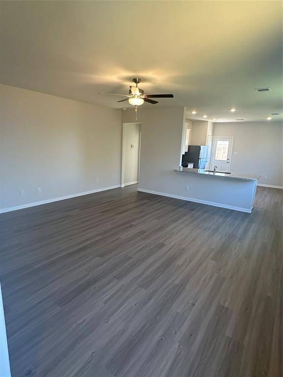 This open layout creates a spacious, connected feel, perfect for both relaxing and entertaining, with the consistent flooring tying the two areas together.