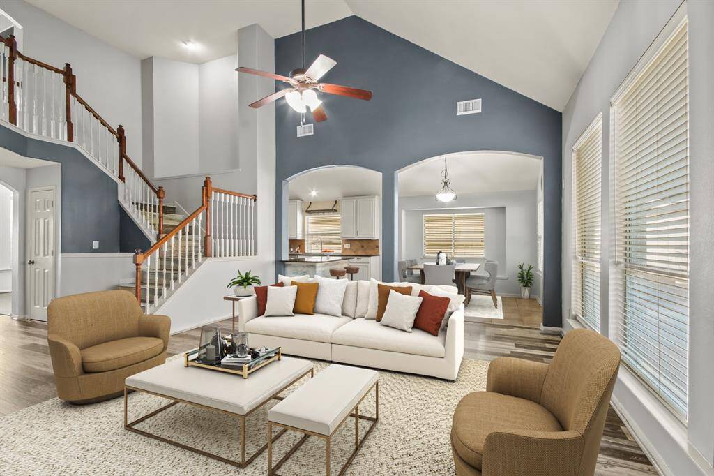 Family living area has tall ceilings / staged furniture photo