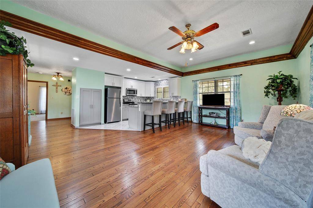 Family room and kitchen view. Built in pantry area, stainless steel appliances and refrigerator is included.
