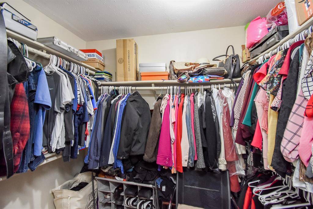 The primary walk-in closet stores and organizes all of your belongings with lots of shelving and railings.