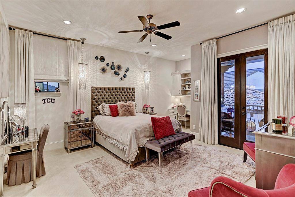 Upstairs Bedroom #1 | This cute secondary bedroom upstairs is fit for a princess with gorgeous hanging lighting, private balcony, and built-in desk nook for studying