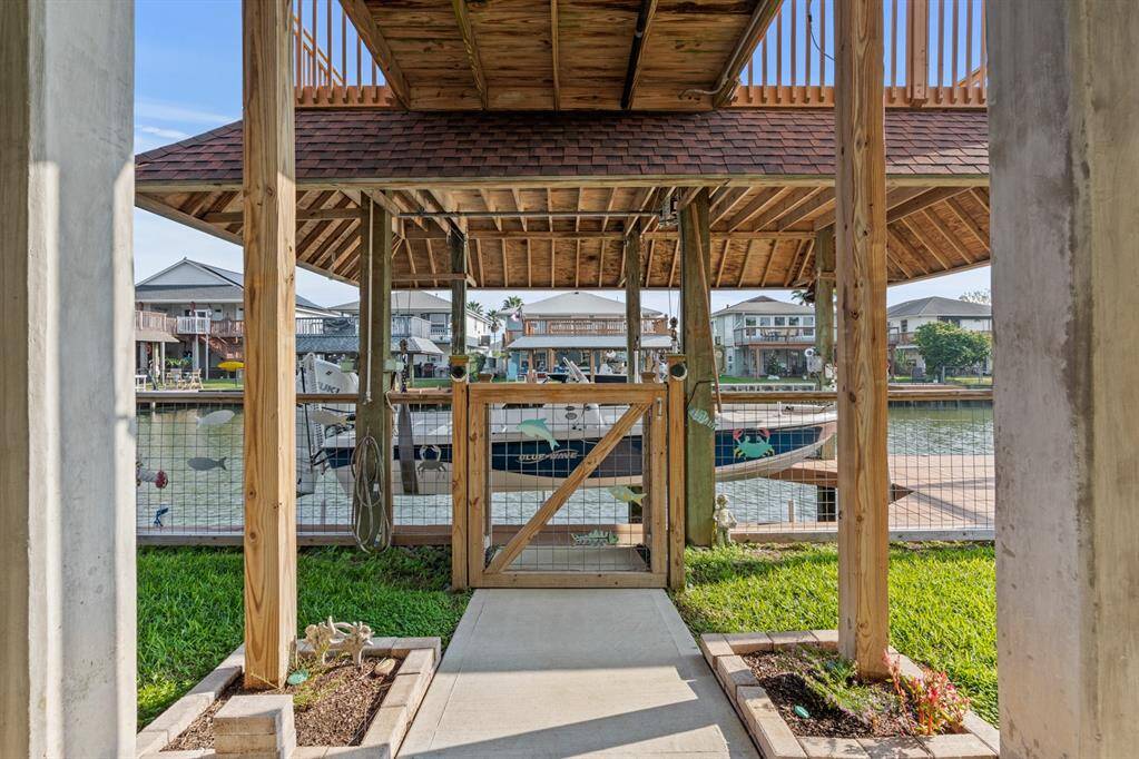 Fully fenced, walkway leading to boathouse.