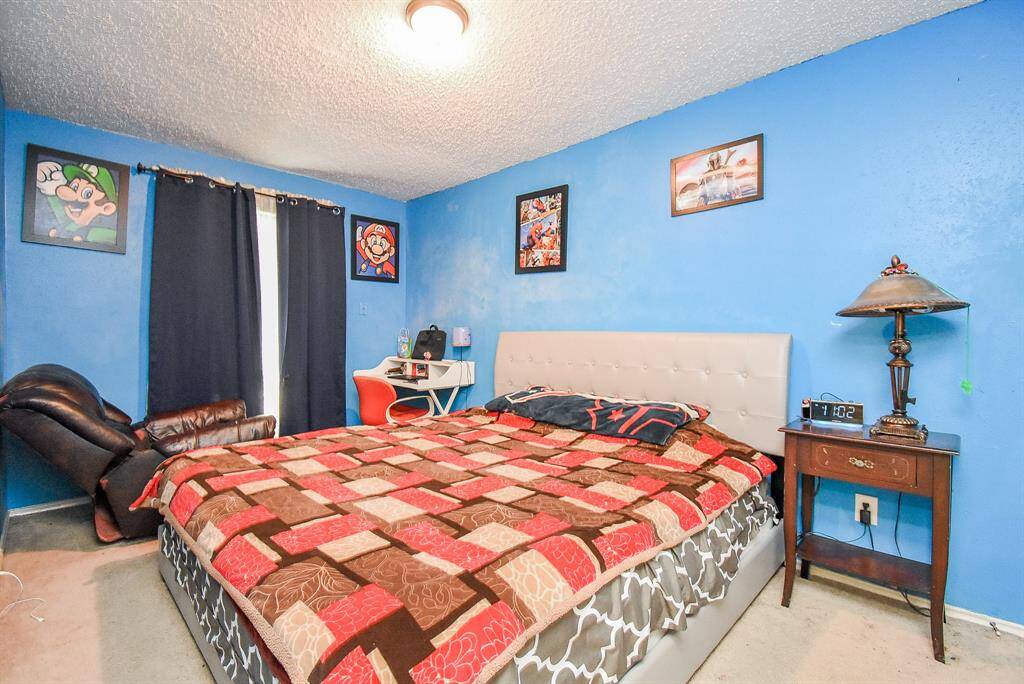 Comfortably place your oversized pieces in this naturally lit carpeted secondary bedroom.