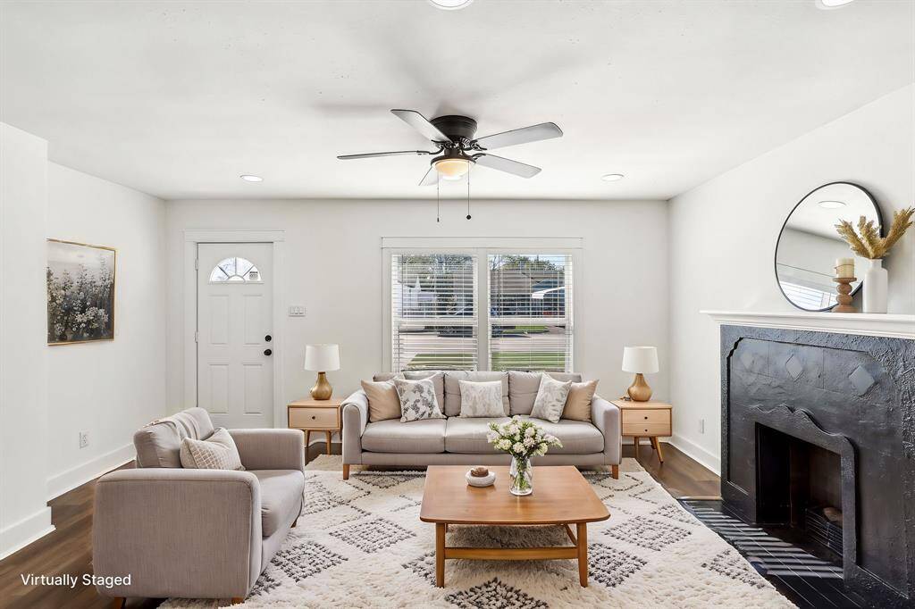 View of the living area with beautiful black fireplace!