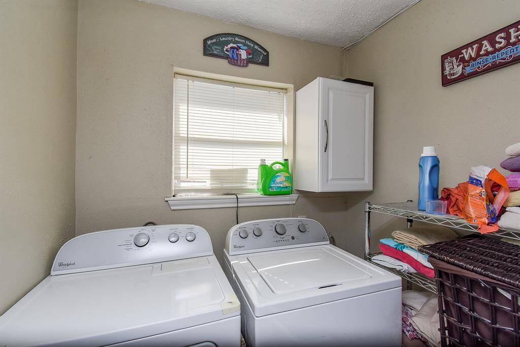 Dual-laundry appliances and storage pieces fit well in the utility room.