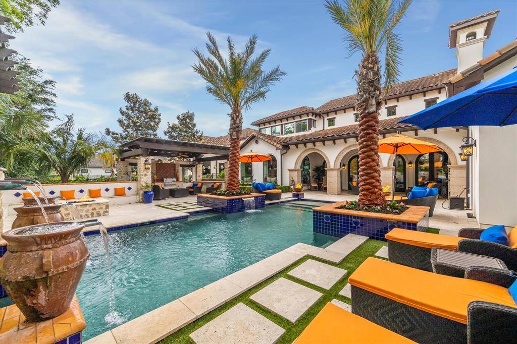 Relax by the pool and listen to the cascading water feature in your Private backyard Paradise.