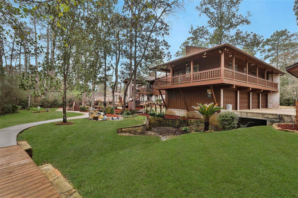 Left side property view of 4 car garage and guest quarters above.