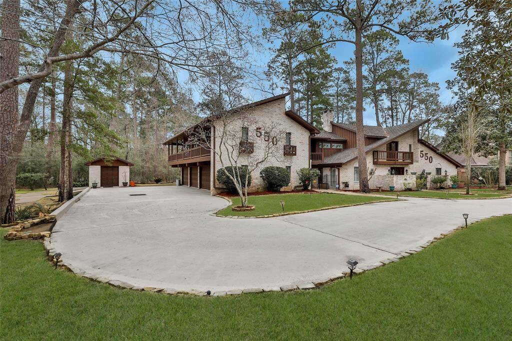 Circle driveway in front for guests - then you drive around to the 4 car garage with ample additional parking.