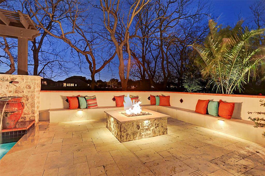 Fire Pit | The built-in seating is the perfect place to relax with friends or family while enjoying your stone fire pit