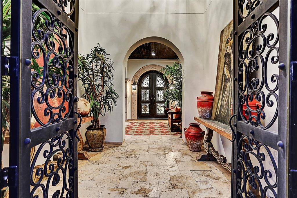 Gorgeous ornamental arched wrought iron doors welcome you into the private courtyard with fountain and casita guest suite complete with kitchenette and ensuite bathroom