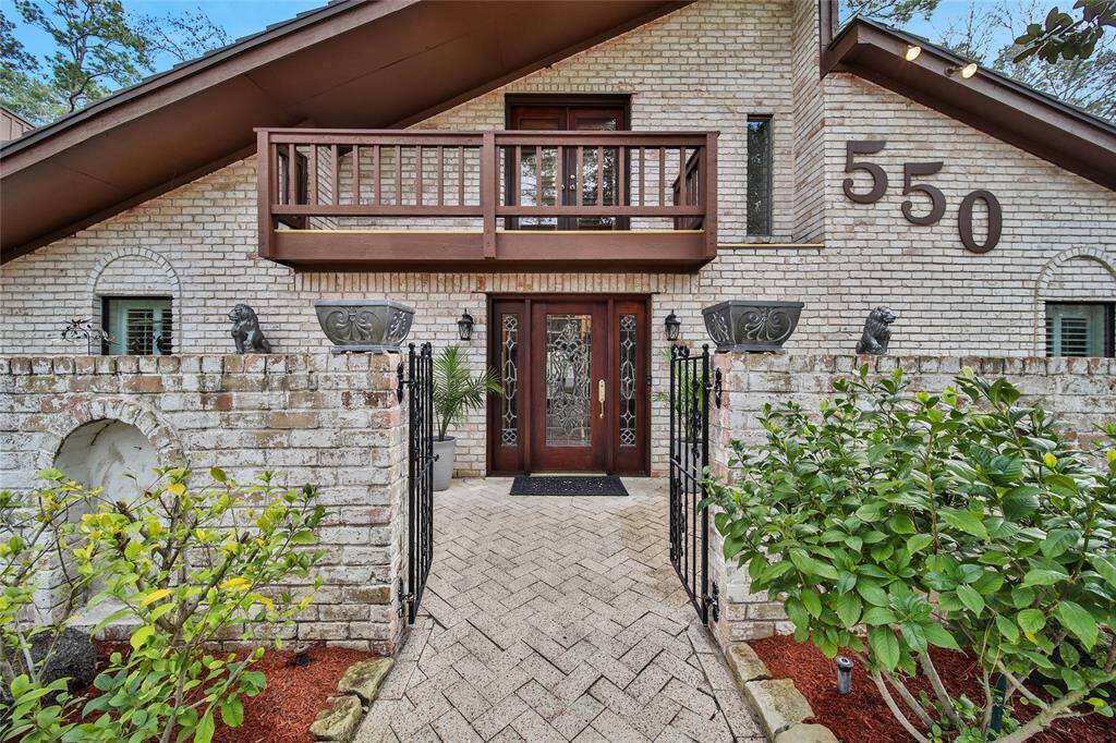 Wrought iron gates lead to the front courtyard and entry. Welcome to 550 Peachtree Park in River Plantation!