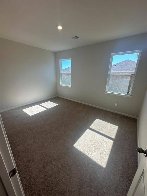 The master retreat is a serene and spacious sanctuary, featuring two large windows that fill the room with natural light and provide a tranquil view of the outdoors.