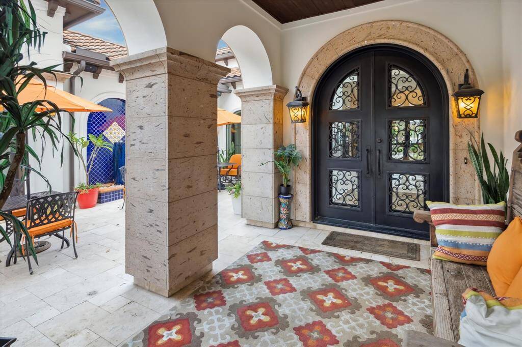 Enter into your Private Courtyard featuring Arched Entries, Travertine flooring, and extensive Canterra stone accents.