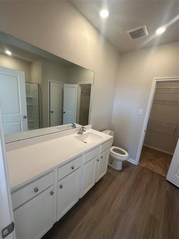 Adjacent to the bathroom, a walk-in closet provides generous storage for clothing and accessories, helping to keep the space organized and functional.