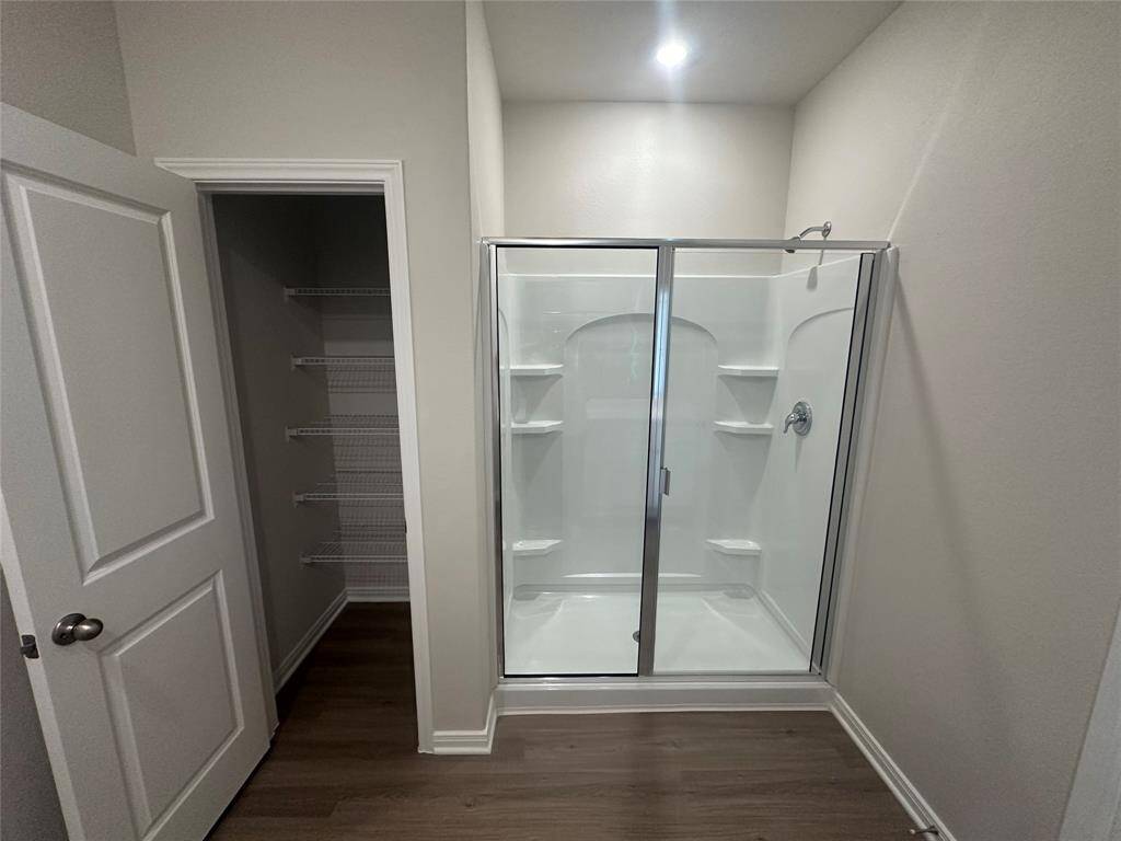 Adjacent to the shower, a convenient storage closet provides ample space for towels, toiletries, and other essentials, keeping the space tidy and organized.