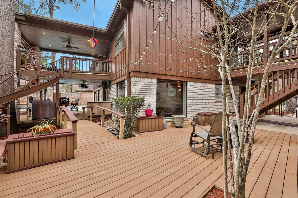 Deck view through to the pool area. Spiral stairs lead you up to the second floor covered patio that has access to the upstairs owner's retreat. LED G40 Outdoor patio lighting. Multiple TREX built cabinets stay!