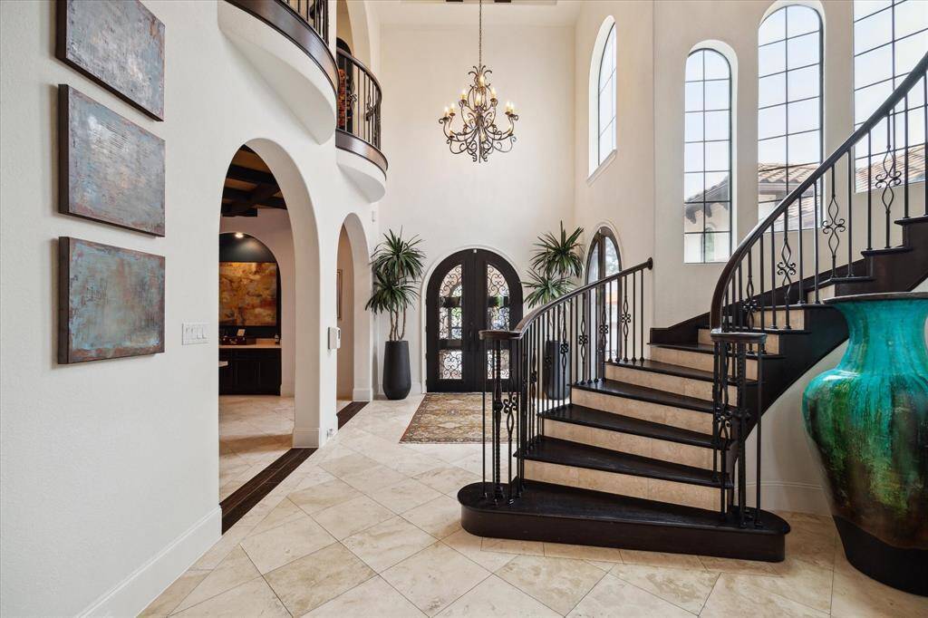 The Grand Foyer is a Masterpiece on its own featuring a Dramatic curved Staircase. This stunning showpiece is Graced by 24 foot soaring ceilings.