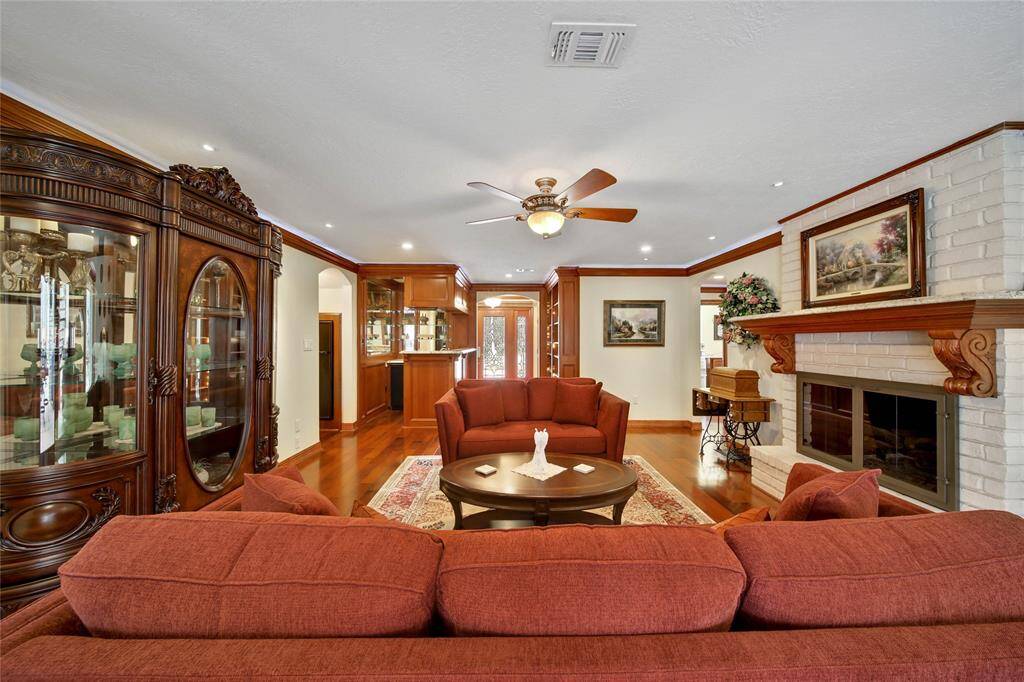 Family room view through to the entry. You still have time to cozy up to that gorgeous fireplace!