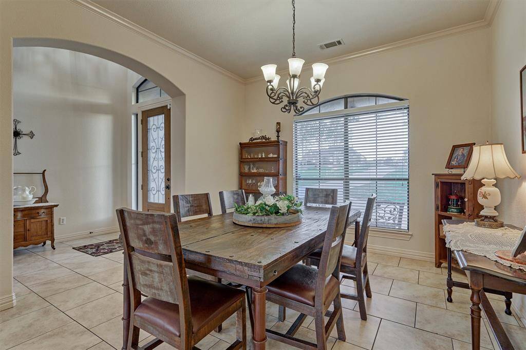 The formal dining room has elegant arched accents and offers a lovely view of the spacious front yard.