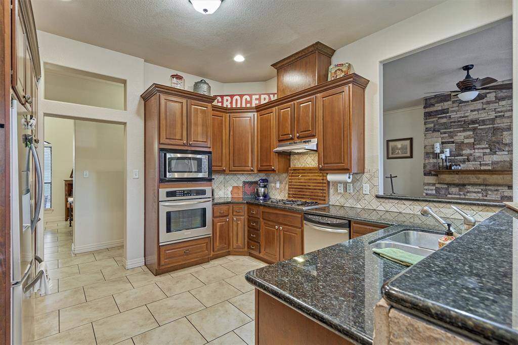 The kitchen opens to a cozy sitting room just beyond, creating a connected and inviting space perfect for relaxing or entertaining.