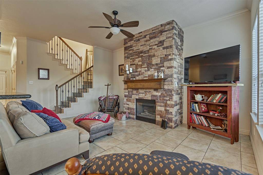 This cozy space has a floor-to-ceiling stone fireplace, creating a warm and eye-catching focal point in the room.