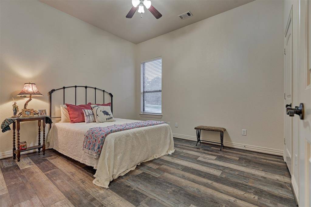 The first guest bedroom is conveniently located on the main floor and features the same luxury vinyl flooring, a spacious closet, and easy access to a full bath.