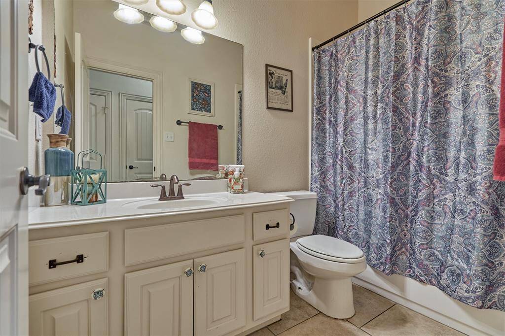 The first-floor full bath is located near the guest bedroom, offering convenience and comfort for guests or multi-generational living.