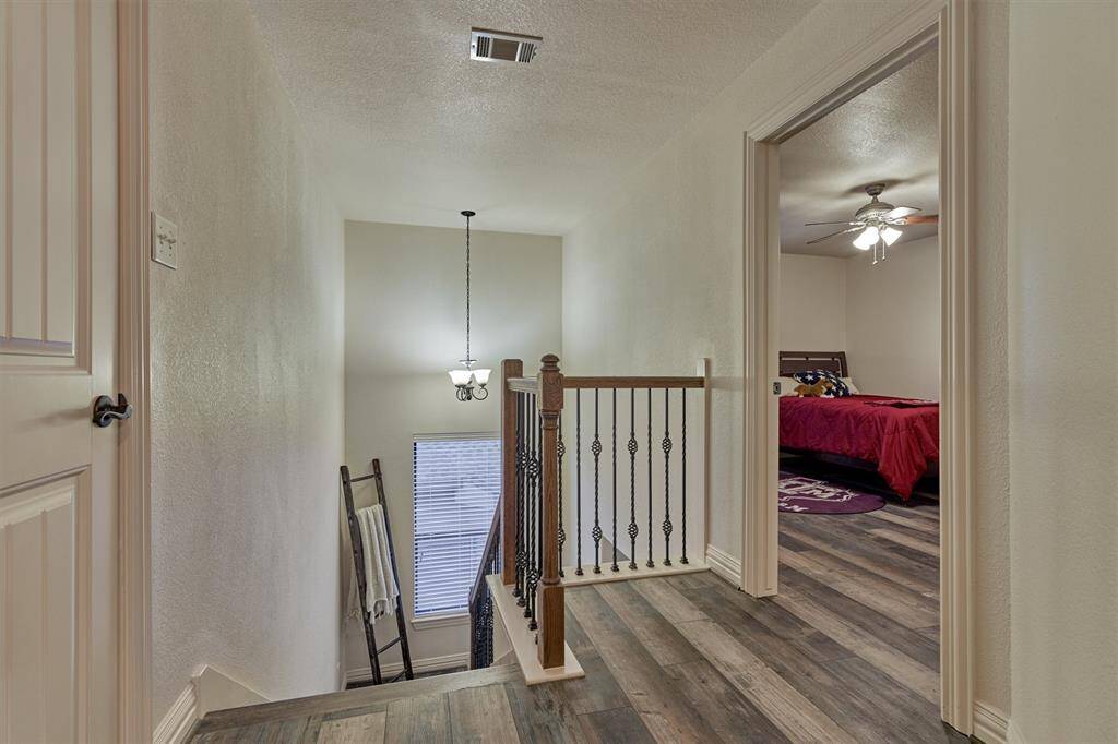 The second floor continues with the same luxury vinyl plank flooring found downstairs and includes two additional bedrooms, a full bath, and a spacious game room.