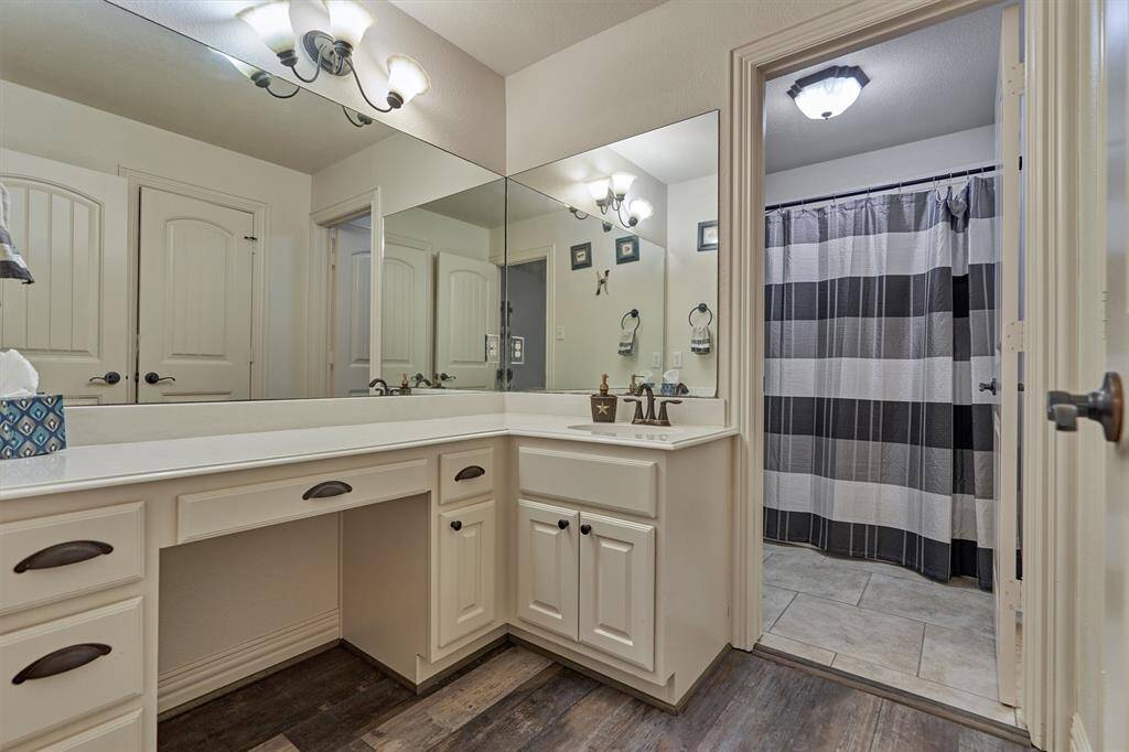 This guest bedroom features a private sink and vanity area, with a shared shower and toilet space located just beyond—ideal for convenience and privacy.