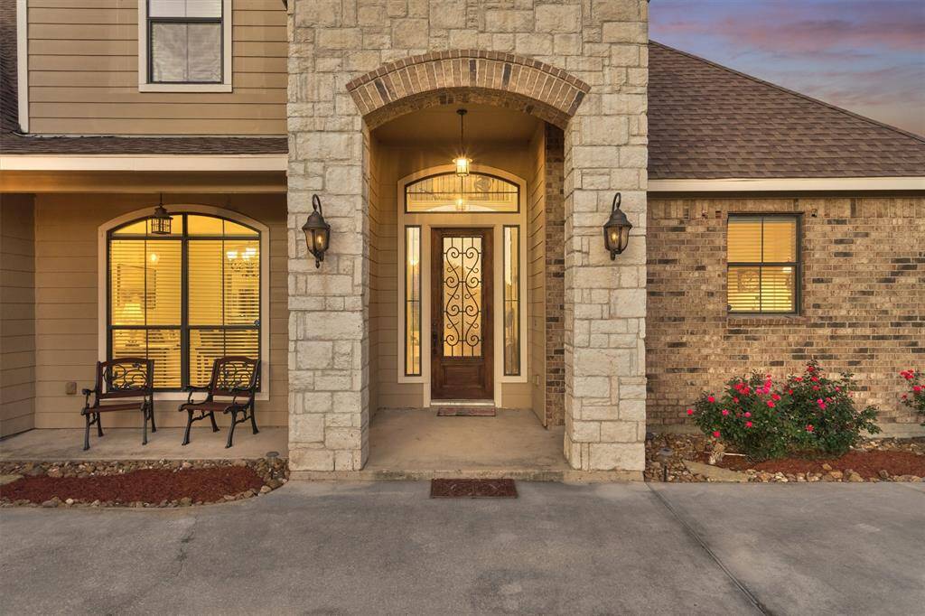The exterior showcases a beautiful blend of brick and stone, complemented by painted Hardie siding for added texture and visual appeal.