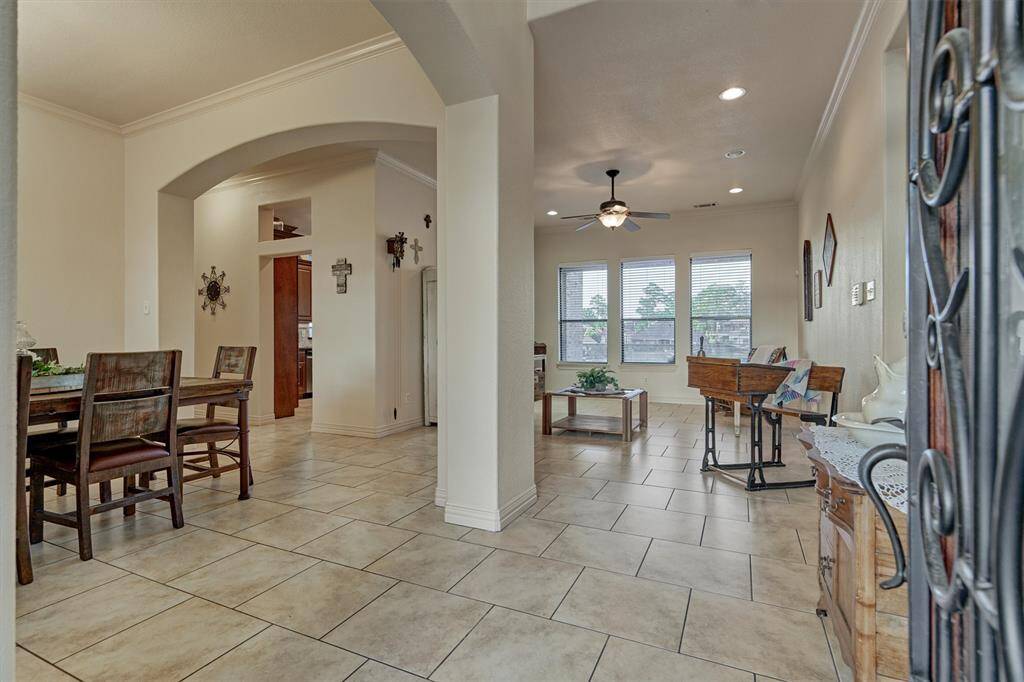 The entryway opens to the formal dining room and one of two inviting living areas, creating a warm and welcoming first impression.