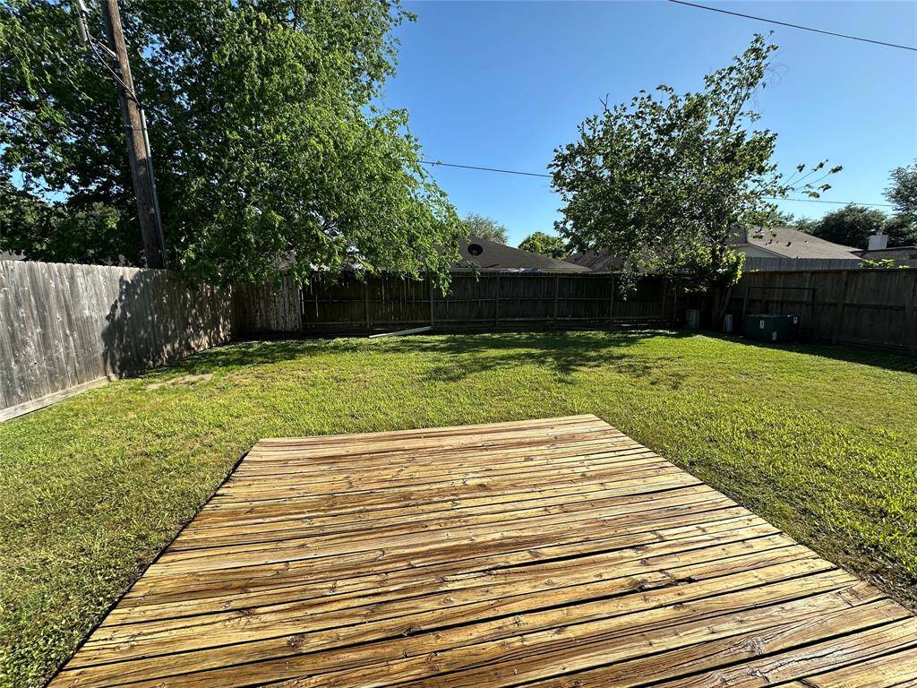 Spacious backyard with wood deck