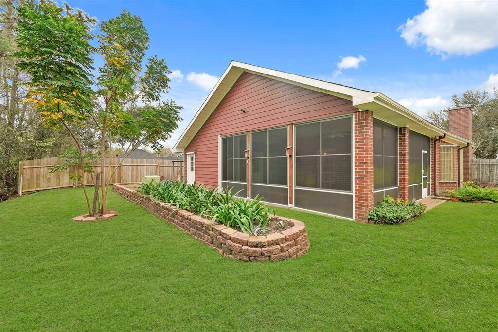 This charming home features a spacious screened-in porch, surrounded by a well-maintained lawn and tasteful landscaping. The brick exterior adds a classic touch, and the fenced yard provides privacy and a perfect space for outdoor enjoyment.