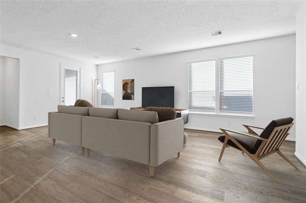 Gather the family and guests together in your lovely family room! Featuring high ceilings, recessed lighting, custom paint, gorgeous engineered wood floors and large windows with blinds that provide plenty of natural lighting throughout the day.