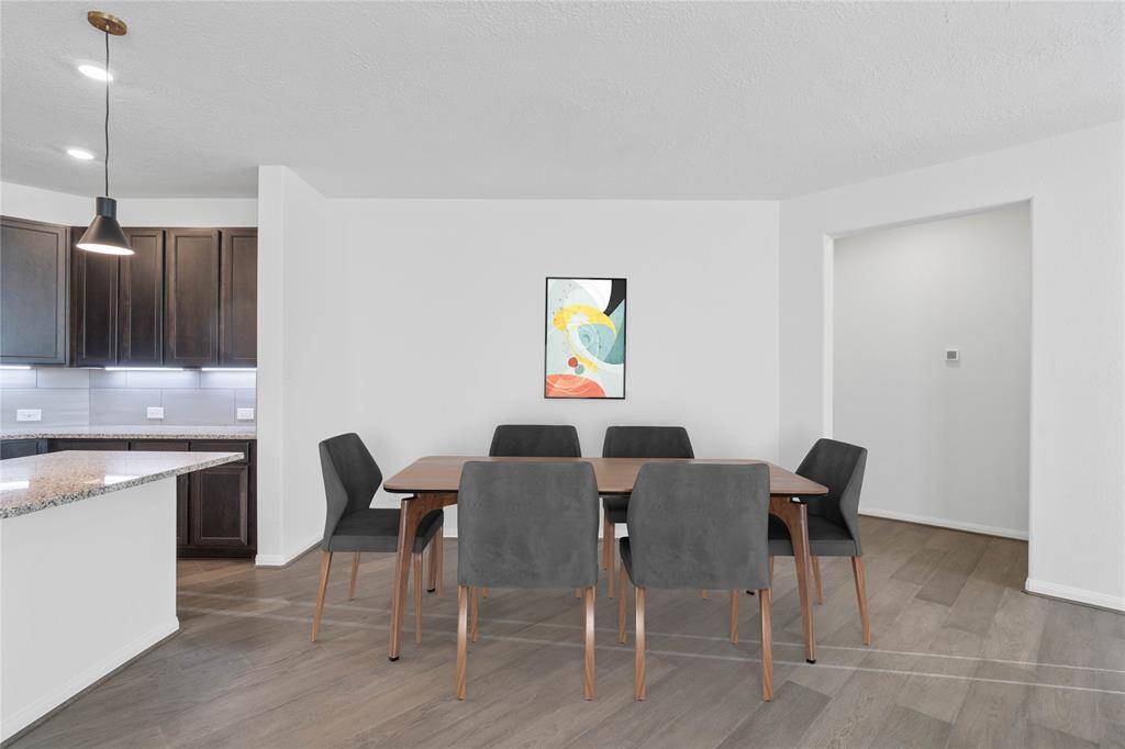 Start your day off right with a cup of coffee sitting with your family in the lovely dining area! Featuring custom paint, engineered wood flooring, and wonderful access to the gorgeous kitchen.