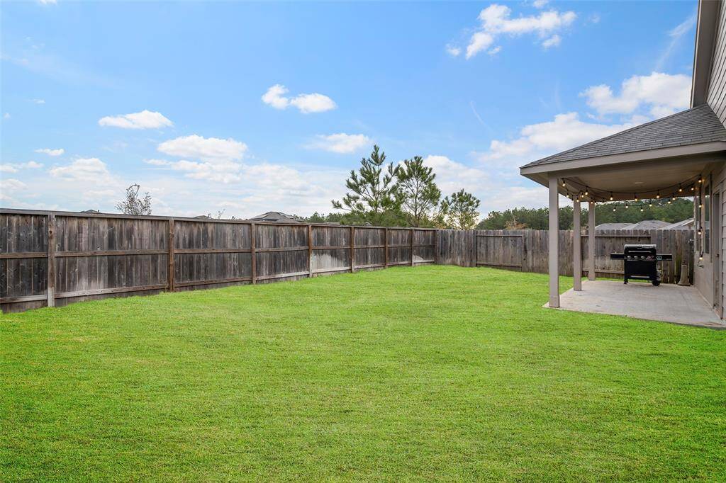 Spacious backyard with Covered Patio and fenced backyard for entertaining friends and family.