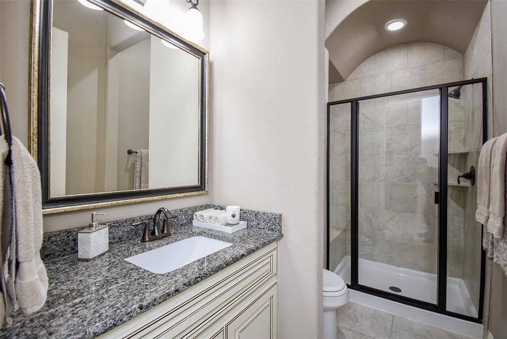 Second full bath shared by the secondary bedrooms well appointed with a spacious shower.