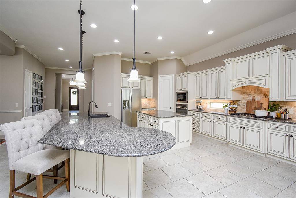 Extended island countertop and second center island provide a bounty of space to prep, serve and enjoy.