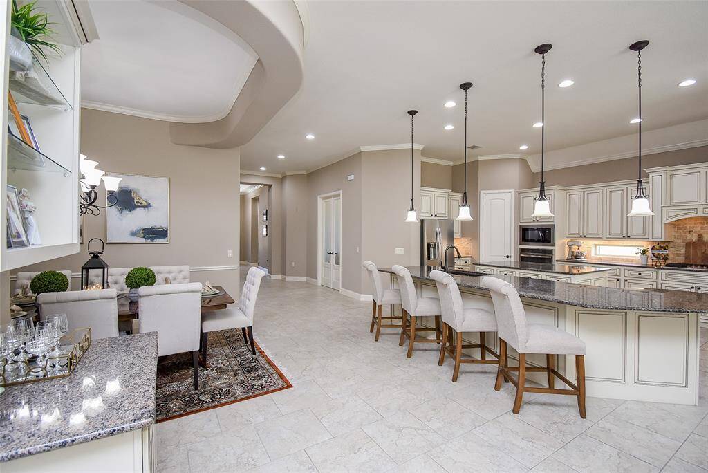 Ceiling detail provides the perfect visual separation for the dining room.
