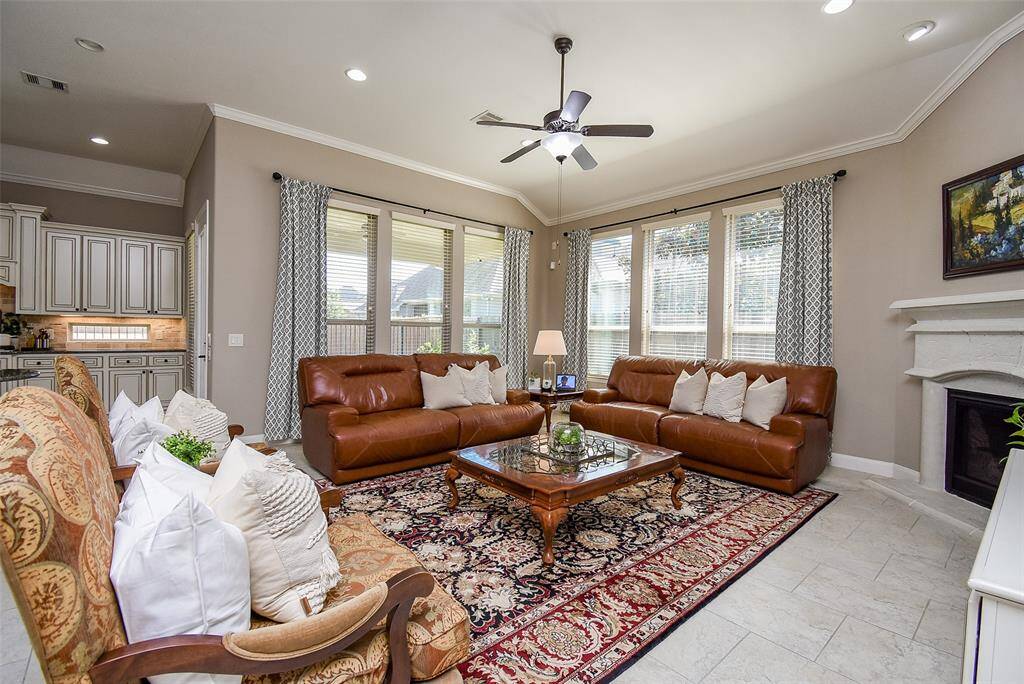 Living area overlooks the back patio and beyond to the manicured park.