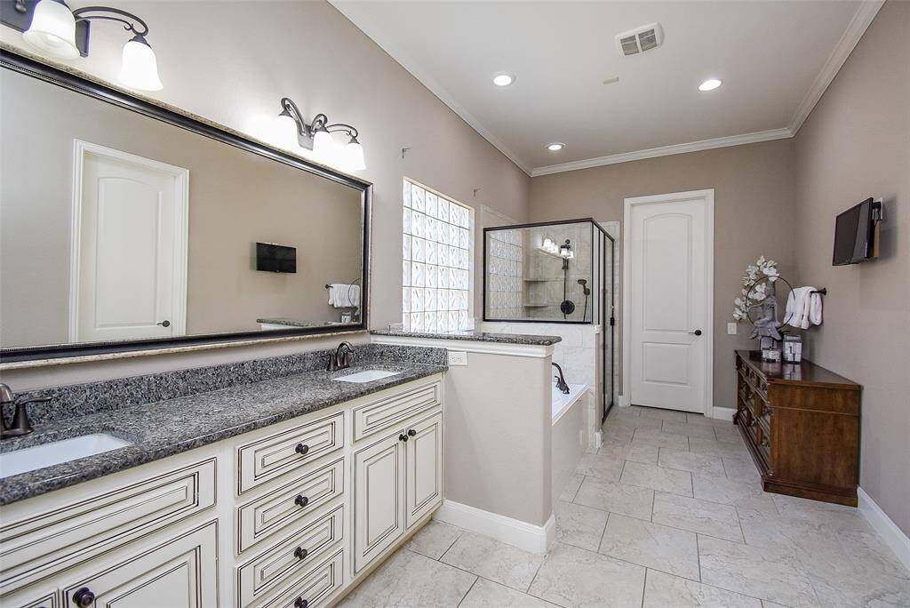 Primary bathroom with double sinks; jacuzzi tub and separate shower.