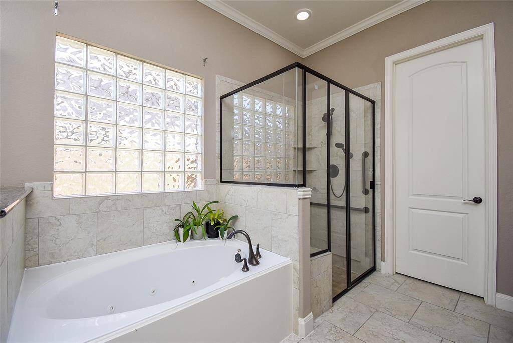 Primary bathroom has attached oversized primary closet that further attaches to the laundry room for easy access to wash, dry and fold.